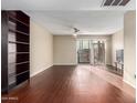 Bright living room with dark wood floors and a view to the patio at 1601 W Sunnyside Dr # 154, Phoenix, AZ 85029