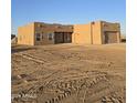 Newly built home with stucco exterior, attached garage, and desert landscaping at 38422 W Buckeye Rd, Tonopah, AZ 85354