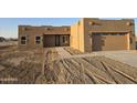 Newly constructed home with stucco exterior, attached garage, and walkway at 38422 W Buckeye Rd, Tonopah, AZ 85354