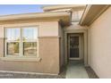 Home exterior showcasing entryway with security door and stone walkway at 19051 N Aztec Point Dr, Surprise, AZ 85387