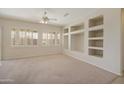 Living room featuring built-in shelving and carpet at 19051 N Aztec Point Dr, Surprise, AZ 85387