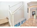 Inviting entryway with staircase, built-in bench, and tile flooring at 35202 N 30Th Dr, Phoenix, AZ 85086