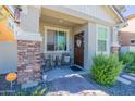 Inviting front porch with stone accents and seating at 29405 N 123Rd Gln, Peoria, AZ 85383