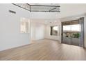Spacious living room with high ceilings, hardwood floors, and a fireplace at 12641 N 18Th Pl, Phoenix, AZ 85022