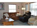 Living room with leather furniture, coffee table and large windows at 8500 E Southern Ave # 586, Mesa, AZ 85209