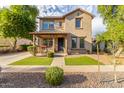Two-story house with front porch and landscaping at 15402 W Old Oak Ln, Surprise, AZ 85379
