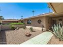 Landscaped patio area with drought-tolerant plants and walkway at 12620 W Parkwood Dr, Sun City West, AZ 85375