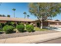 Single-story home with a landscaped yard and two-car garage at 12620 W Parkwood Dr, Sun City West, AZ 85375