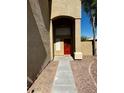 Red front door entryway with stone pathway at 15270 W Taylor St, Goodyear, AZ 85338