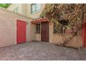 Private patio with brick pavers and a red door at 6730 W Monterosa St, Phoenix, AZ 85033