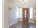 Inviting entryway with tiled floor and elegant wood door at 126 S Lucia Ln, Casa Grande, AZ 85194