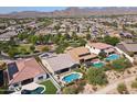 Aerial view of a luxury home community, showcasing homes with pools and mountain views at 2229 N Beverly Pl, Buckeye, AZ 85396