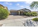 Two-story home with a gray two-car garage and paved driveway at 2229 N Beverly Pl, Buckeye, AZ 85396
