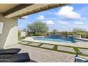 Covered patio overlooking a refreshing pool and spa at 2229 N Beverly Pl, Buckeye, AZ 85396