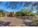 Stunning Spanish-style home with a brick driveway and beautifully landscaped grounds at 37295 N Boulder View Dr, Scottsdale, AZ 85262