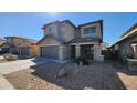 Two-story house with gray siding and a two-car garage at 9415 W Palm Ln, Phoenix, AZ 85037