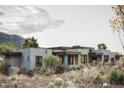 Contemporary home with stone facade and desert landscaping at 10071 E Aniko Dr, Scottsdale, AZ 85262