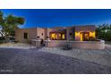 Exterior of a stucco home with a brick driveway at dusk at 26615 N 71St Pl, Scottsdale, AZ 85266
