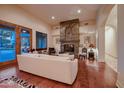 Cozy living room featuring a fireplace and hardwood floors at 26615 N 71St Pl, Scottsdale, AZ 85266