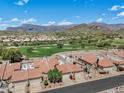 Aerial view of a community with golf course and mountain views at 8870 E Greenview Dr, Gold Canyon, AZ 85118