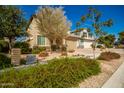 Two story home with tan exterior and two car garage at 2440 E Saint Catherine Ave, Phoenix, AZ 85042