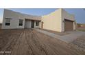 Newly built home with two-car garage and desert landscaping at 38434 W Buckeye Rd, Tonopah, AZ 85354