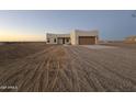 Newly built home with two-car garage and desert landscaping at 38434 W Buckeye Rd, Tonopah, AZ 85354