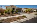 Single-story home with two-car garage and well-manicured landscaping at 17657 W Buckhorn Trl, Surprise, AZ 85387