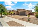 Single story home with landscaped front yard and two-car garage at 21487 E Arroyo Verde Dr, Queen Creek, AZ 85142