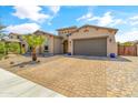 Single story home with landscaped front yard and two-car garage at 21487 E Arroyo Verde Dr, Queen Creek, AZ 85142