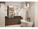 Modern bathroom boasts a freestanding tub and double vanity with marble countertops at 2136 E Paradise Ln, Phoenix, AZ 85022