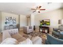 Spacious living room featuring comfy seating and a large TV at 18195 W Redwood Ln, Goodyear, AZ 85338