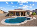 Inviting kidney-shaped pool with a large patio area at 18195 W Redwood Ln, Goodyear, AZ 85338