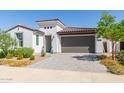 Single-story home with a two-car garage and landscaped yard at 12075 N San Clemente St, Surprise, AZ 85388