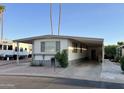 Single-wide manufactured home with carport and landscaped yard at 11411 N 91St Ave # 217, Peoria, AZ 85345