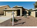Single story house with tan exterior and two car garage at 5984 W Geronimo Ct, Chandler, AZ 85226