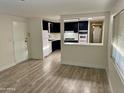 Living room with laminate flooring and open kitchen at 11411 N 91St Ave # 217, Peoria, AZ 85345