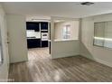 Living room with laminate flooring and open kitchen at 11411 N 91St Ave # 217, Peoria, AZ 85345