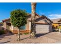 Single-story home with attached garage and desert landscaping at 8714 W Heber Rd, Tolleson, AZ 85353