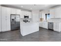 Modern kitchen with white shaker cabinets, stainless steel appliances, and an island at 10784 E Angus Ln, Coolidge, AZ 85128