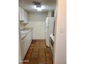 Simple kitchen with white cabinets and tile floor at 3416 N 44Th St # 5, Phoenix, AZ 85018