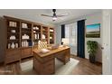 Spacious home office with wooden desk and bookcase at 10910 E Oro Ave, Mesa, AZ 85212