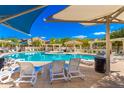 Community pool with lounge chairs and shade structures at 2402 E 5Th St # 1481, Tempe, AZ 85288