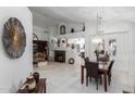 Bright dining area with dark wood table and chairs, adjacent to living room at 5839 E Jensen St, Mesa, AZ 85205