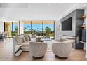 Open living space with fireplace, large windows, and golf course views at 6311 E Phoenician Blvd # 21, Scottsdale, AZ 85251