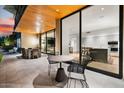 Outdoor patio with dining furniture and views into the modern kitchen at 6311 E Phoenician Blvd # 21, Scottsdale, AZ 85251