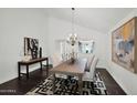 Elegant dining room with a large wooden table, chandelier, and modern art at 7217 E Valley View Rd, Scottsdale, AZ 85250