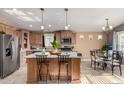 Modern kitchen with island, stainless steel appliances, and breakfast bar at 649 N 67Th Dr # 25, Phoenix, AZ 85043