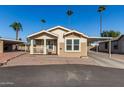 Tan home with carport and small front porch at 649 N 67Th Dr # 25, Phoenix, AZ 85043