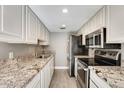 Modern kitchen with granite countertops and stainless steel appliances at 1045 N Granite Reef Rd, Scottsdale, AZ 85257